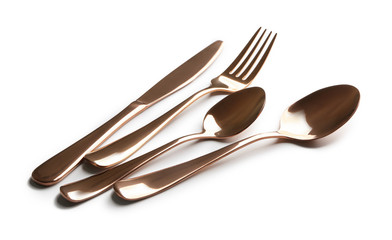 Spoons, fork and knife on white background