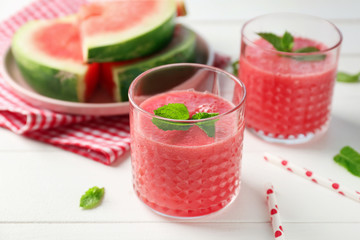Glasses with fresh watermelon smoothie on white table