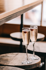 Two glasses of champaigns, Italian sparkling white wine on wooden table against window lights. Food and drink photpgraphy, copyspace, minimalism