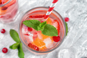 Fresh summer cocktail in glass on light table, closeup