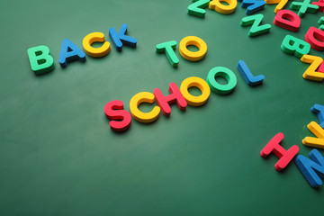 Phrase BACK TO SCHOOL made with letters on color background