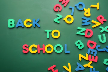 Phrase BACK TO SCHOOL made with letters on color background