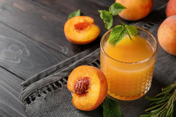 Peach juice in glass on table