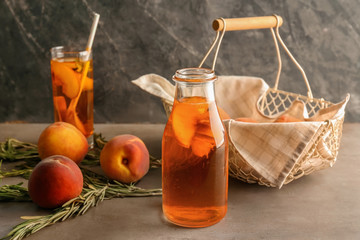 Peach cocktail in glass bottle on table