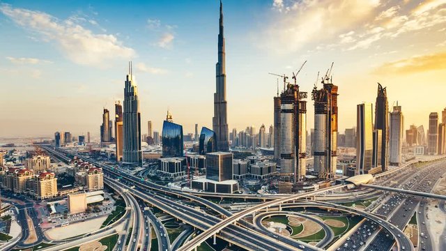 Scenic skyline of downtown Dubai, United Arab Emirates at sunset. Aerial view on highways and skyscrapers. 4K timelapse.