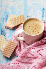 Tasty Christmas coffee or cocoa and sweet cookies on blue wooden background and pink tablecloth. Copy space