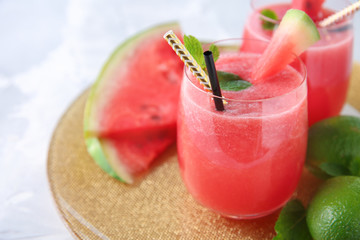 Glass with fresh watermelon smoothie on table