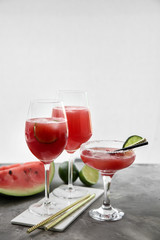 Glasses with fresh watermelon smoothie on grey table