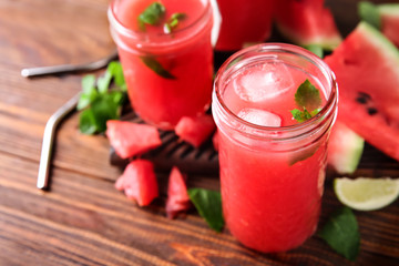 Jar with fresh watermelon smoothie on wooden table