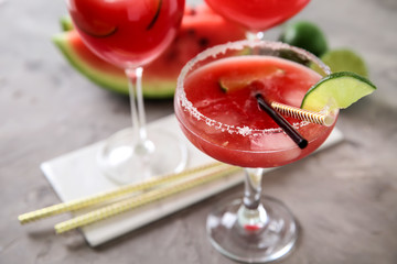 Glass with fresh watermelon smoothie on grey table