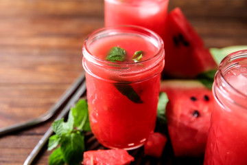 Jar with fresh watermelon smoothie on table
