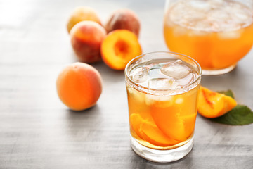 Peach cocktail in glass on table