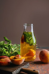 Peach cocktail in bottle on color table