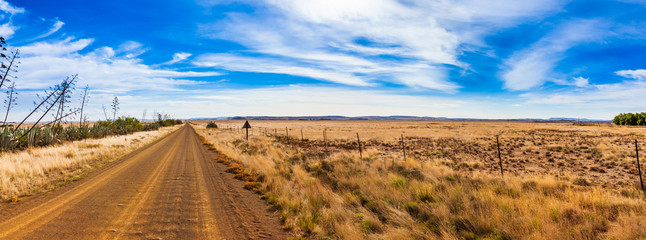 Dirt roads and fields of the Karoo near Gariep dam, South Africa. - obrazy, fototapety, plakaty