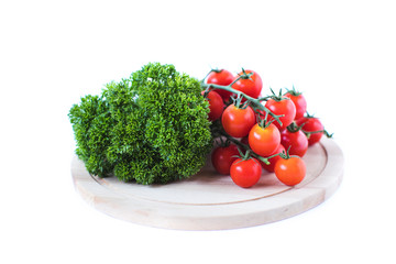 Cherry tomatoes and parsley on a wooden.