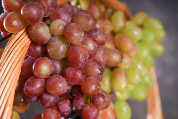 Wicker basket with fresh ripe grapes, closeup