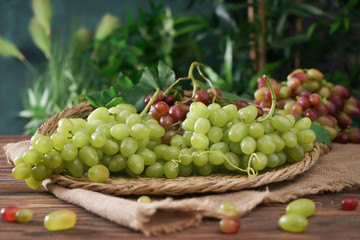 Fresh ripe grapes on wicker tray