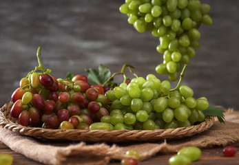 Fresh ripe grapes on wicker tray