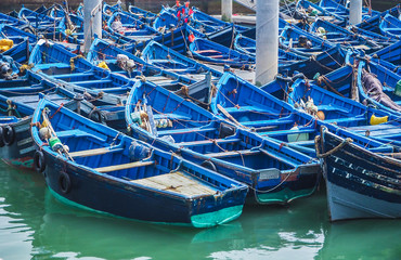 Fototapeta na wymiar Beautiful blue boats in Essaouira old harbor, Morocco