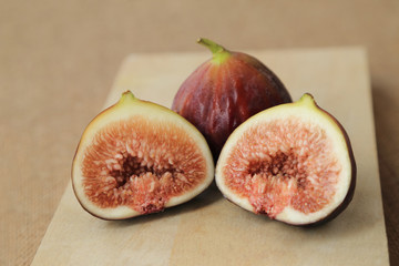 Fresh fruits, figs (Ficus carica) on the wooden plate.