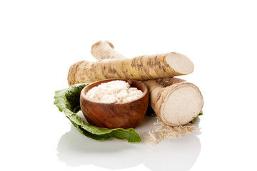 Fresh and grated horseradish roots.