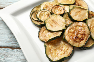 Tasty grilled zucchini on plate, closeup