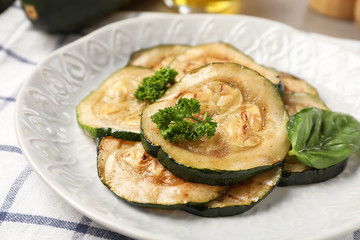 Tasty grilled zucchini on plate, closeup