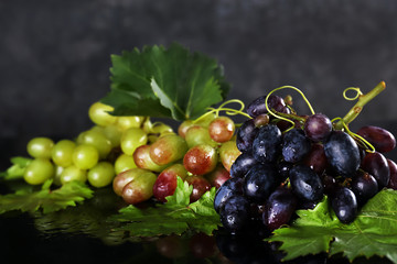Fresh tasty juicy grapes on dark background