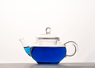 teapot of butterfly pea tea isolated on white background