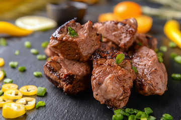 Delicious shish kebab on slate plate, closeup