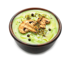 Bowl with tasty zucchini soup and mushrooms on white background