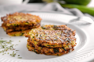 Plate with zucchini pancakes, closeup