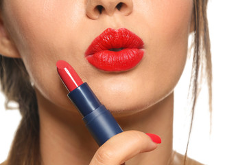 Beautiful young woman with red lipstick on white background, closeup