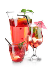 Jug and glasses with fresh raspberry lemonade on white background