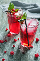 Glasses of fresh raspberry lemonade on wooden table