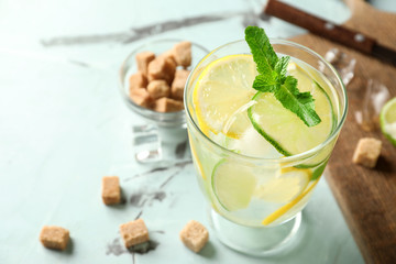 Glass of fresh mojito on light table