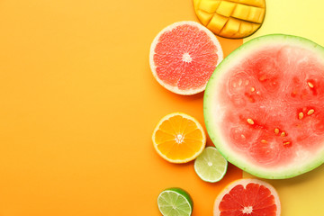 Flat lay composition with various delicious fruits on color background