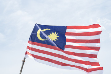 Malaysia flag also known as Jalur Gemilang wave with the blue sky. People fly the flag in conjunction with the Independence Day celebration or Merdeka Day.
