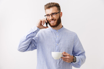 Portrait of a smiling young bearded man in eyeglasses