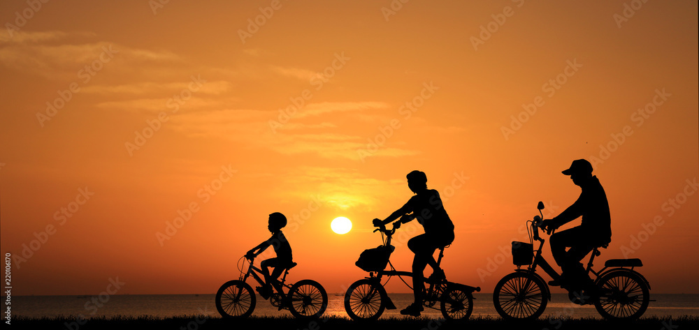 Sticker silhouette family  riding bicycle at sunset sky