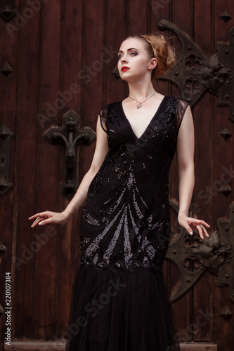 Portrait Goth Girl Wearing Black Dress Stands Near Red Wood Door