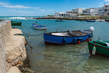 Fototapeta na wymiar Enchanted sea. Boats in the bay of the abbey of San Vito