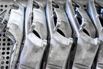 Pile of aluminum automotive parts arm rear, casting process in the automotive factory