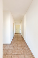 Fototapeta premium White corridor with tiles and closed doors