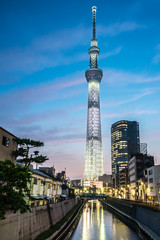 TOKYO, JAPAN - June 22, 2018: Tokyo Skytree, Sumida Ward Urban night scene. Tokyo Skytree tower reflections on the canal. Tokyo Sky Tree is one of the famous landmark in Tokyo.