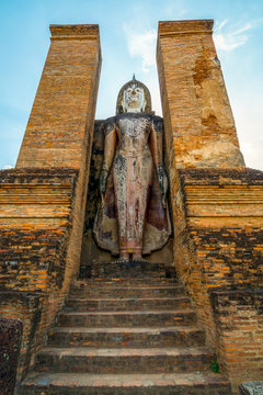 Ancient Buddha Statue at Wat Mahathat in Sukhothai historical park in Sukhothai, Thailand.