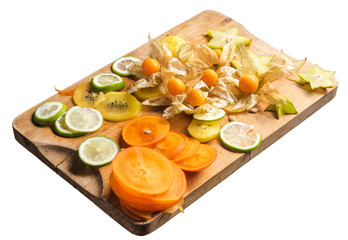 Cut pieces of KIWI fruit, Carambola and persimmon on cutting Board
