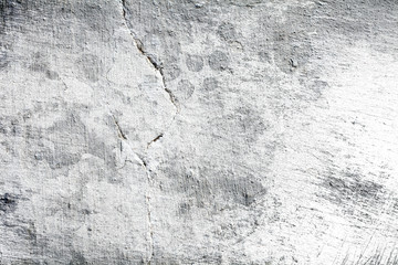 Fragment of a whitewashed wall with damages, textured background