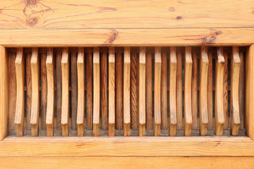 Fragment of a wooden wall with a carved vertical grid
