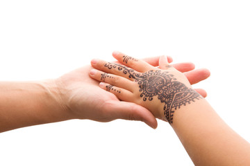 Child hand with henna holding mother's hand.